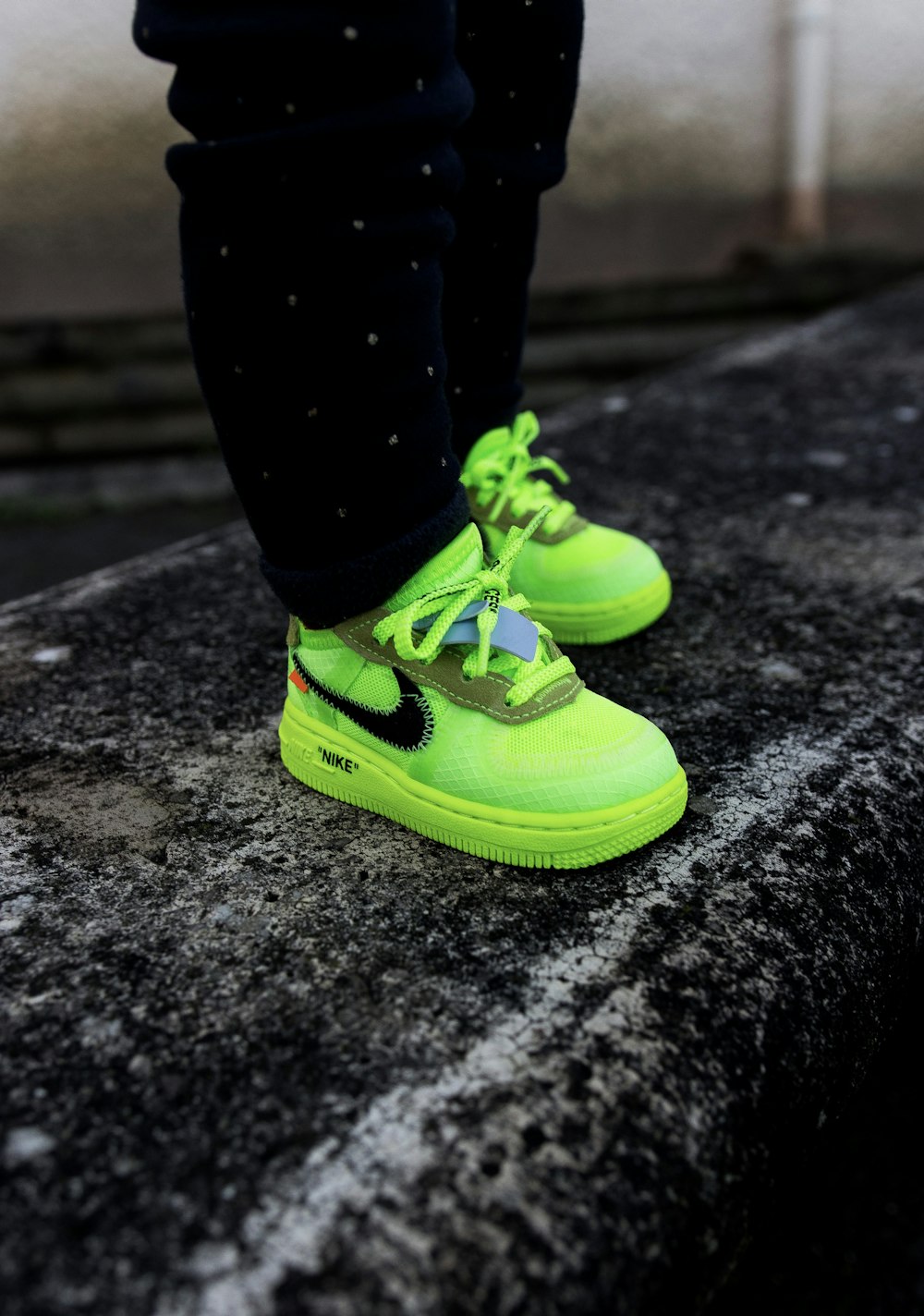 boy in green-and-black Nile shoes