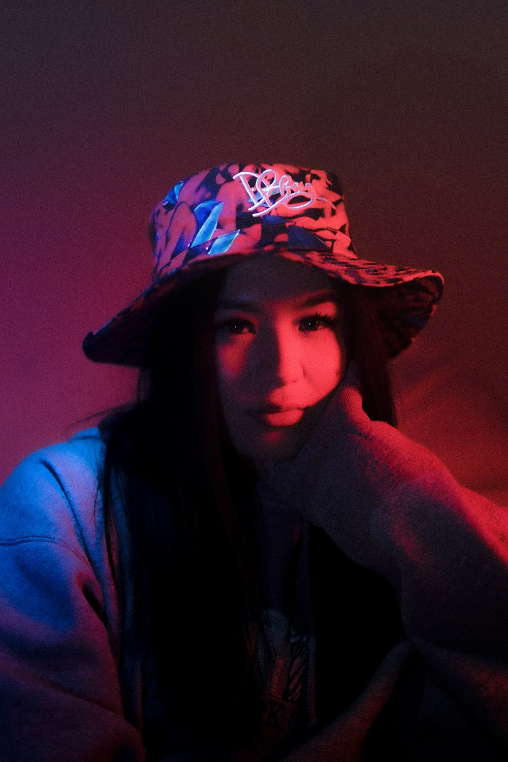 a young woman wearing a hat in a dark room