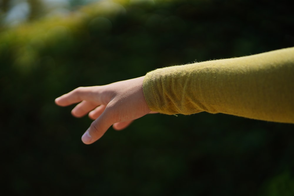 a person's hand reaching for something in the air