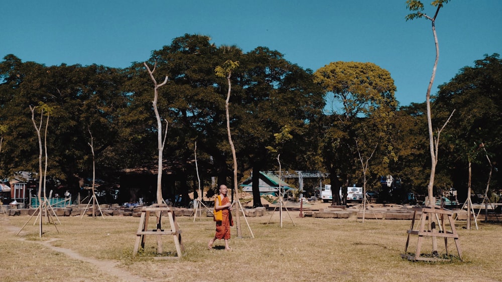 woman wearing orange dress walking on the playground