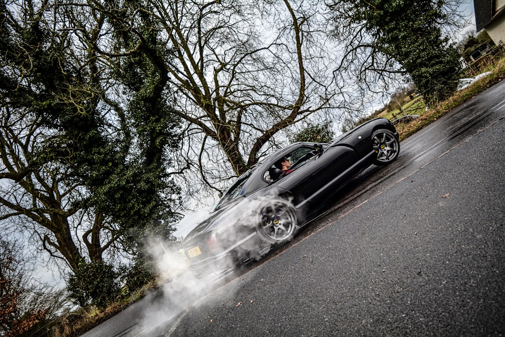 black coupe running on the road