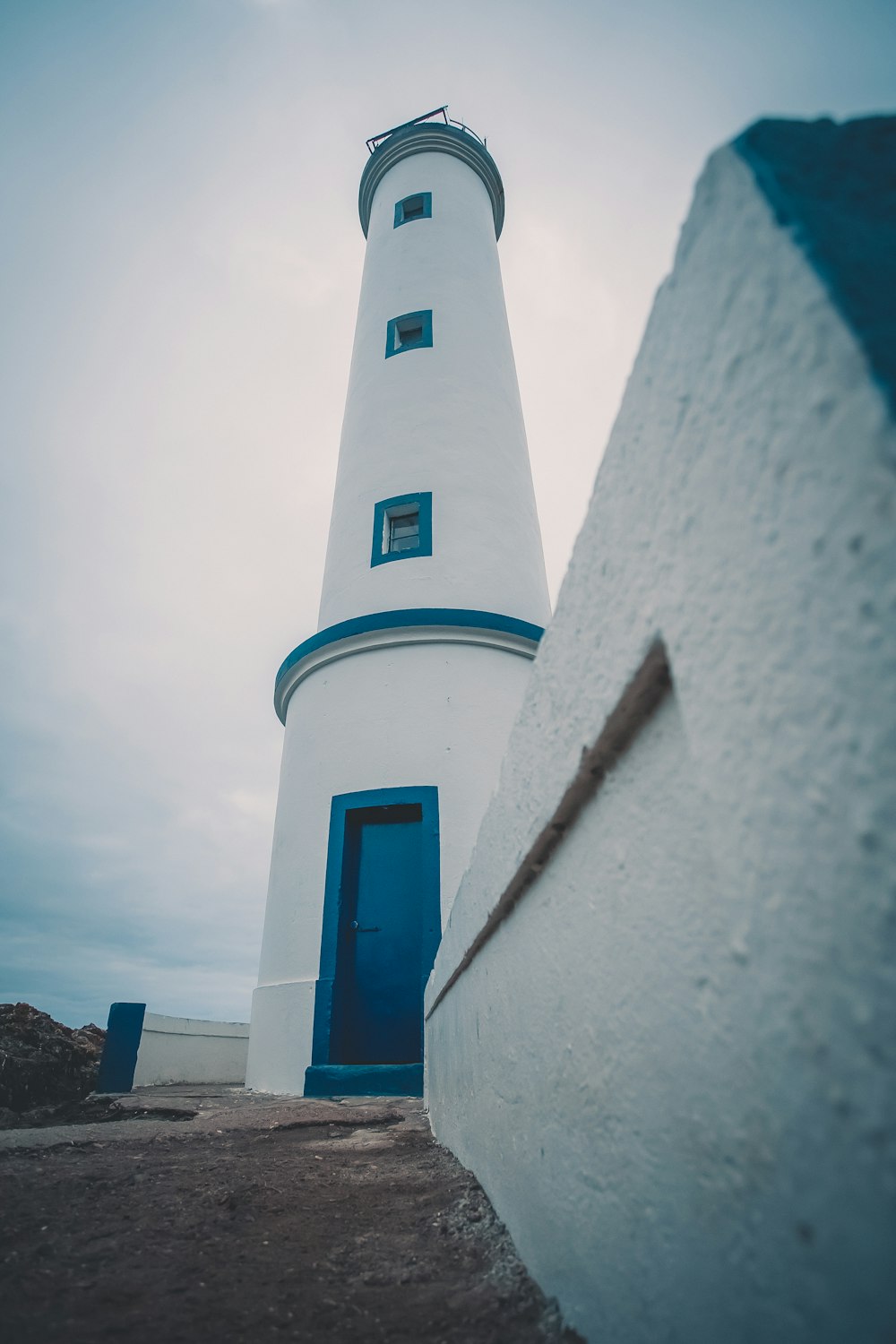 white and blue lighthouse photograph