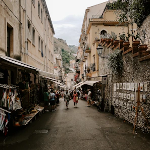 A vibrant market street scene in Italy bustling with people, highlighting local culture.