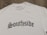 A white T-shirt displayed on a wooden surface with the word 'Southside' printed in bold, gothic-style black lettering. A clothing label reading 'VannyClothingCo.' is visible near the collar, and a blank tag is attached to the shirt.