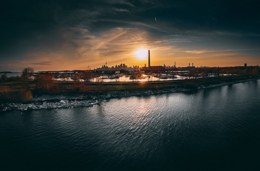 a large body of water with a city in the background