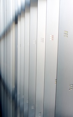 A row of spacious storage lockers with secure locks under natural sunlight.