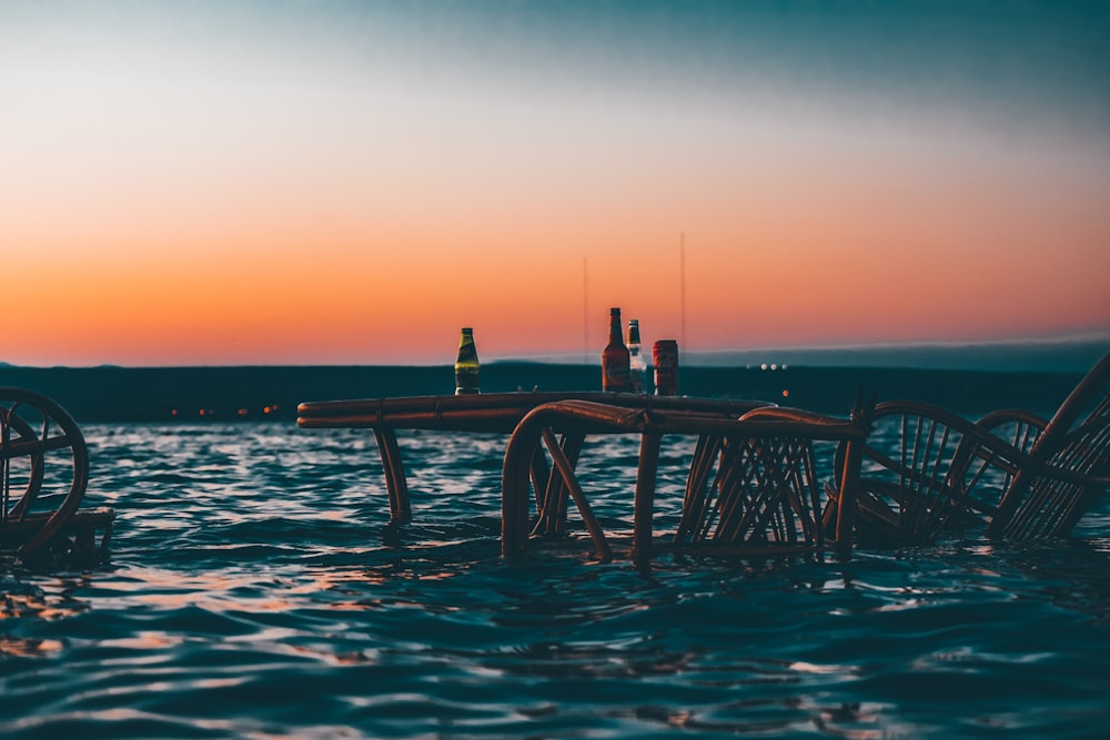 brown ratan chair and table floating on body of water