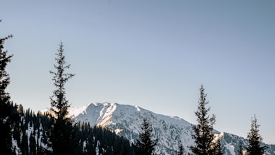 A scenic mountain landscape with a clear blue sky.