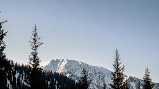 A scenic mountain landscape with a clear blue sky.