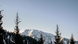 A scenic mountain landscape with a clear blue sky.