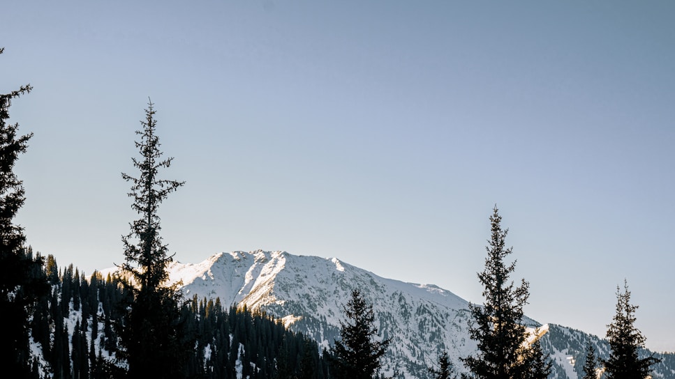 A scenic mountain landscape with a clear blue sky.