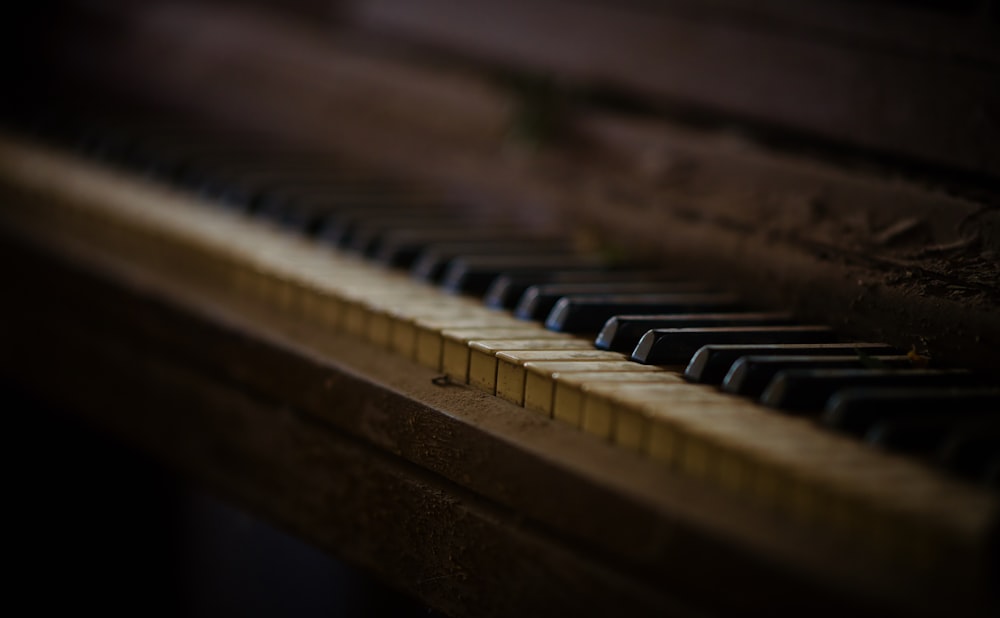 macro photography of brown piano