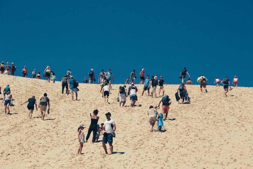 group of people on white sand
