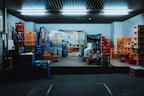 Various plastic storage boxes stacked in a bright room.
