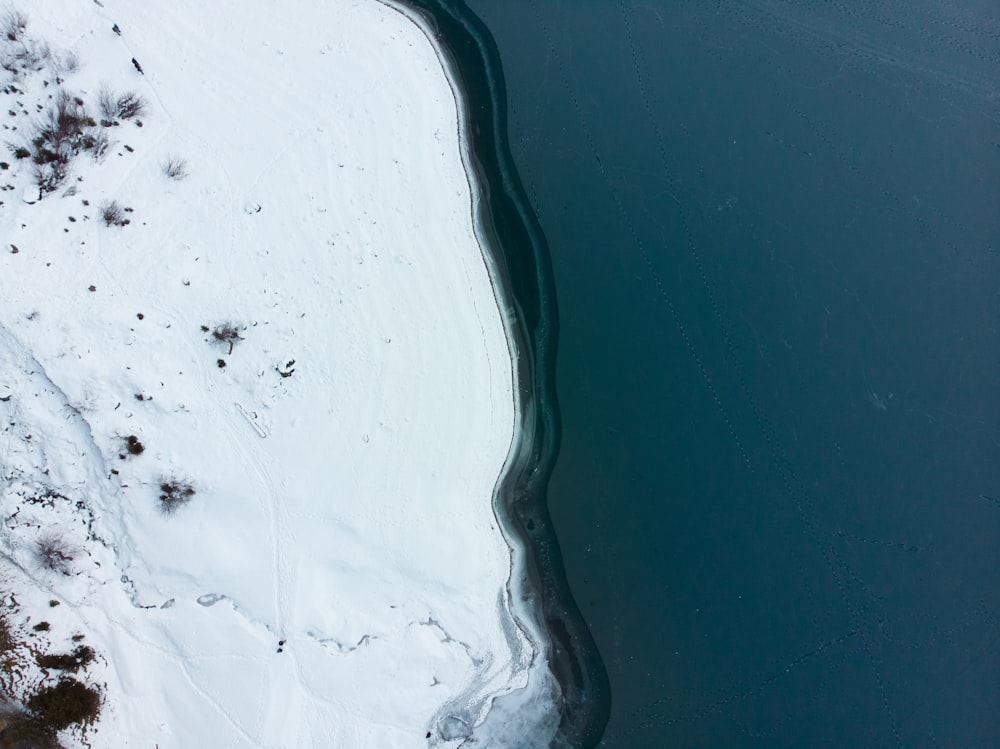 aerial view of snowfield and body of water