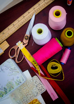 threads with spools beside scissors