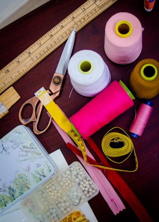 threads with spools beside scissors