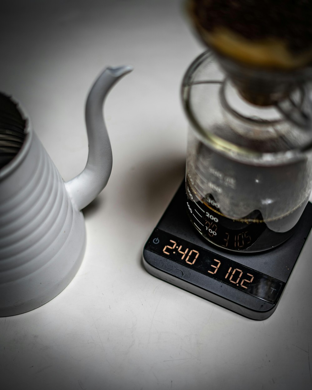 liquid filled measuring cup on device displaying 2:40 and 310.2