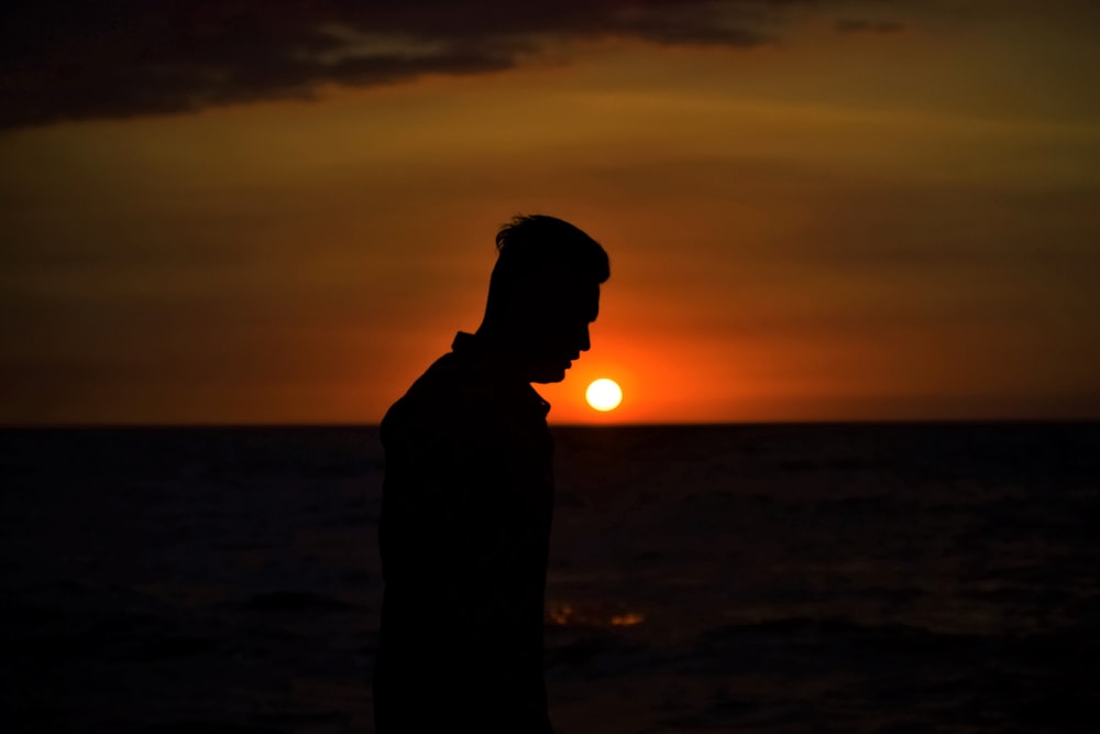 man walking beside sea