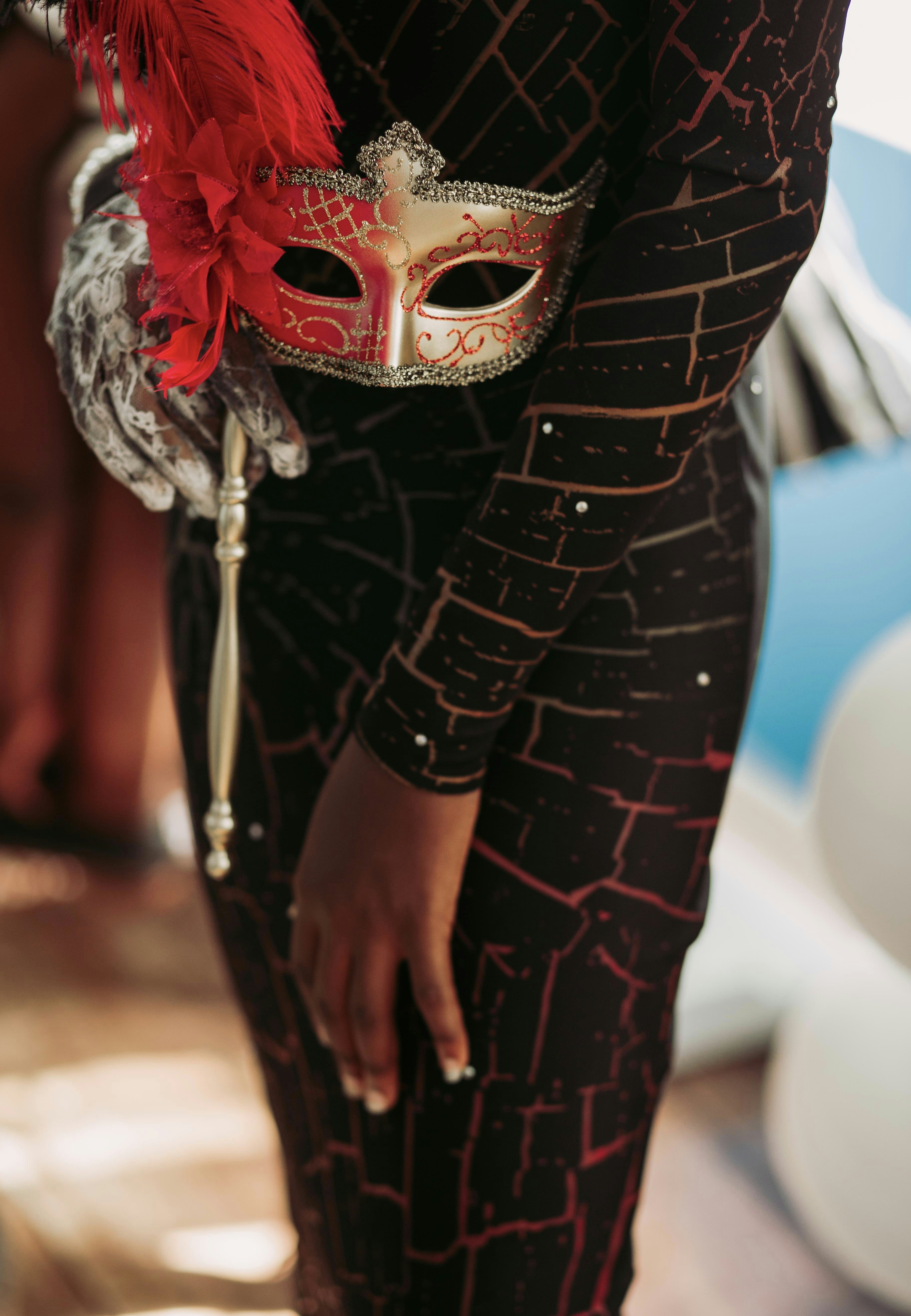 Person in black dress holding gold masquerade mask photo  Free Human Image  on Unsplash