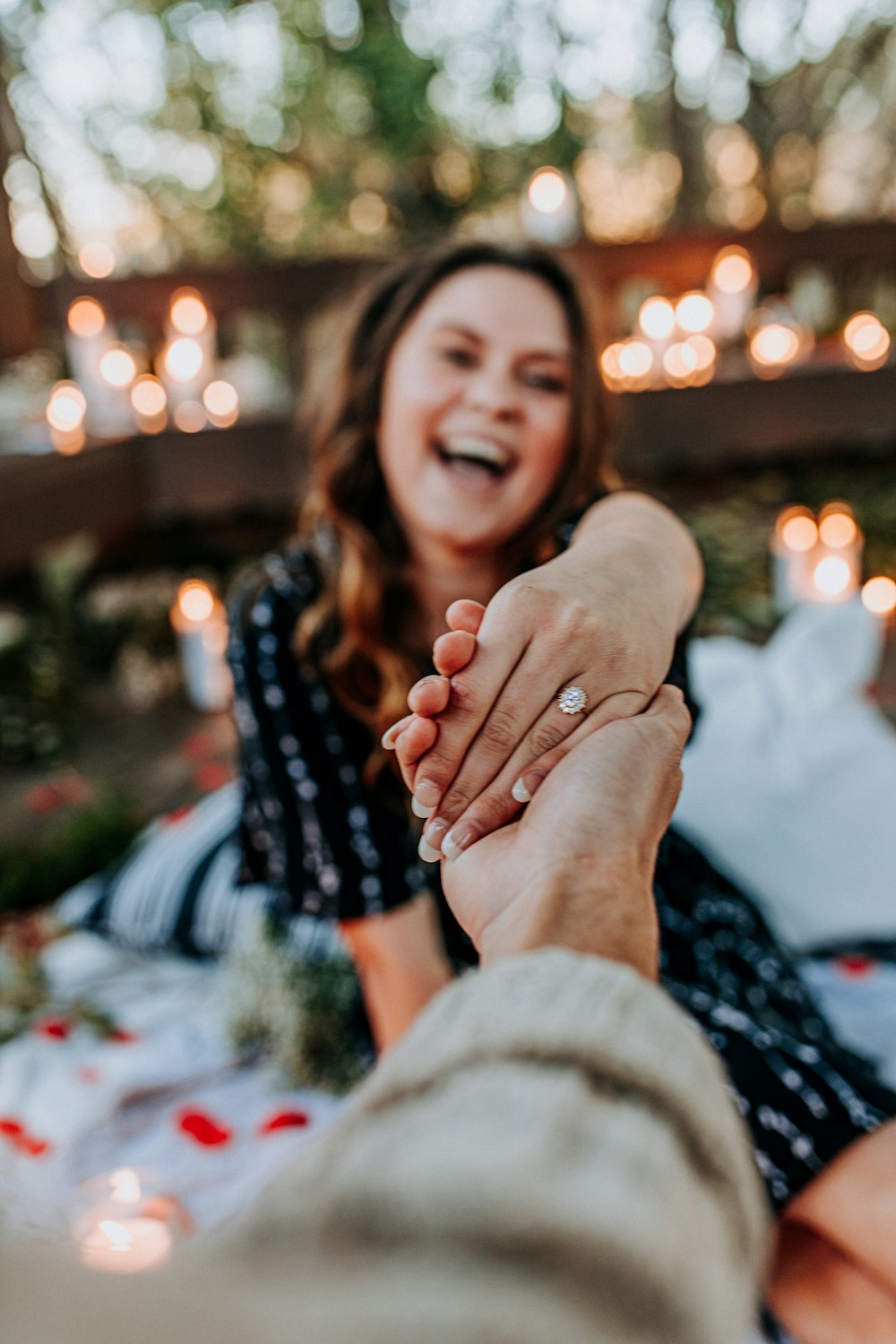 smiling woman holding person's hand