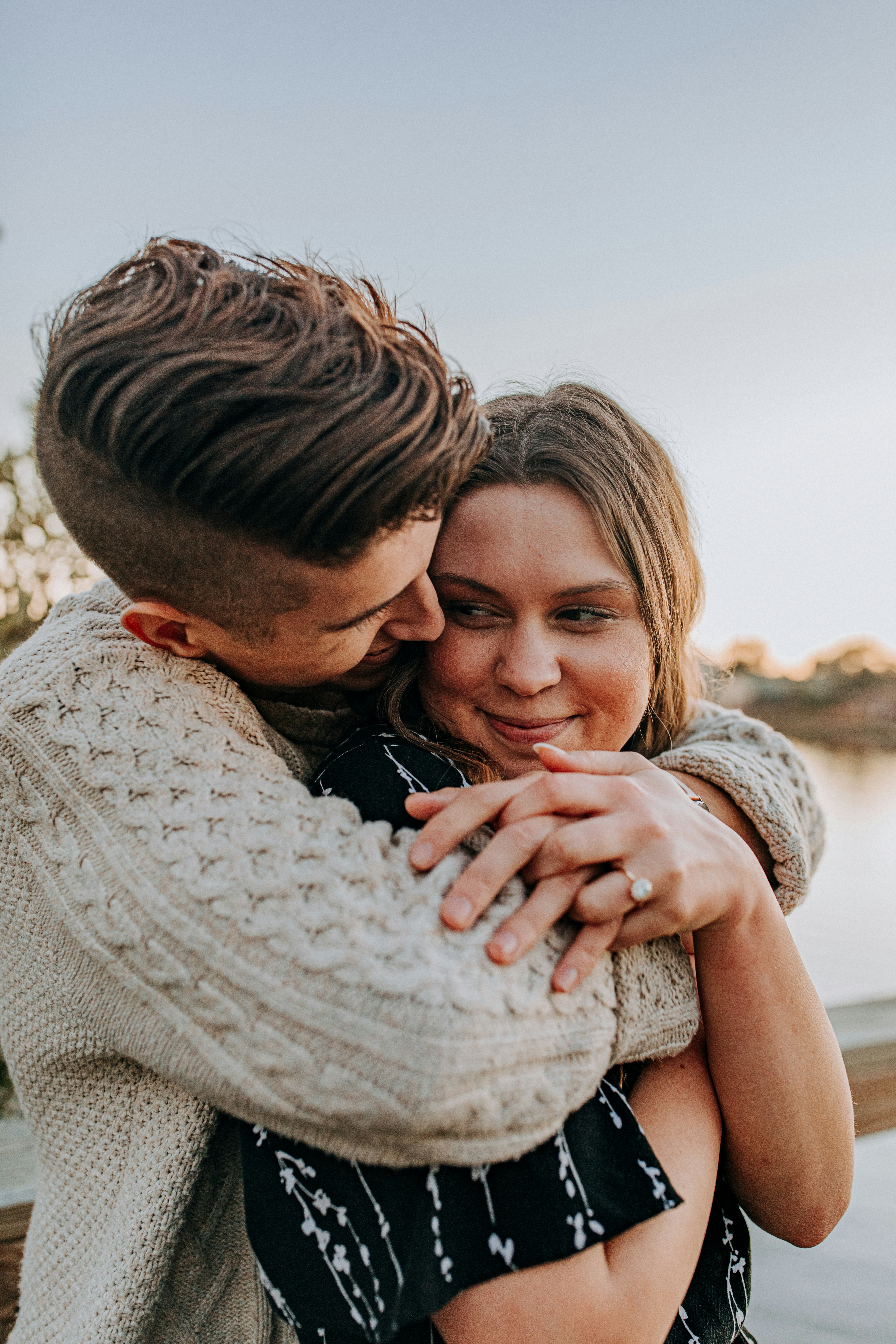 great photo recipe,how to photograph engagement, engaged, ring, hands, couple, in love, sweater, girl meets boy, proposal, florida, usa, marriage, young adults, candles, light, rose petals, happy, cute; man hugging woman by her back during day
