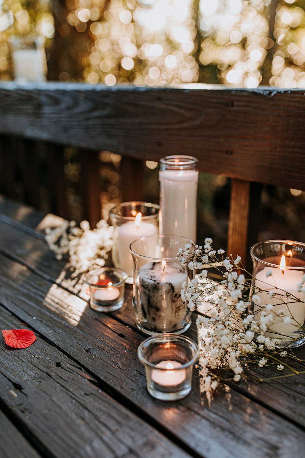 lit candles with white flower