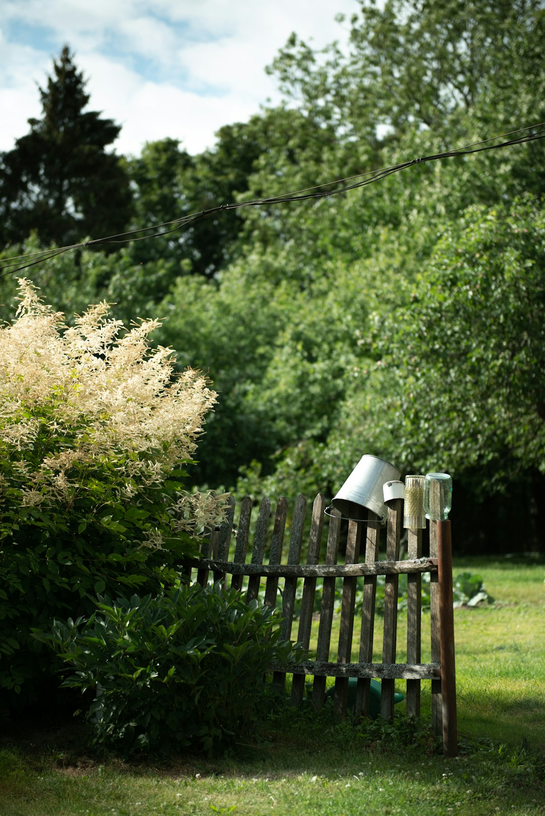  silver bucket on wooden fence bucket