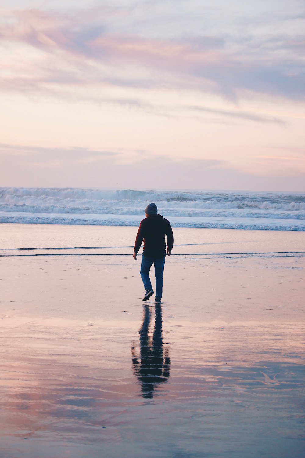 man walking on the shoreline