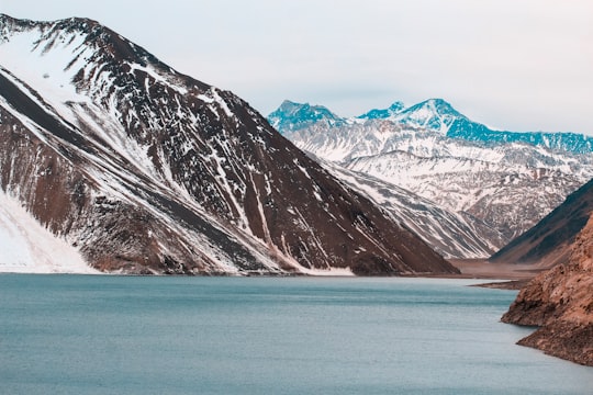 photography of snow-capped mountain range during daytime in Embalse el Yeso Chile