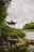 a gazebo sitting on top of a lush green hillside