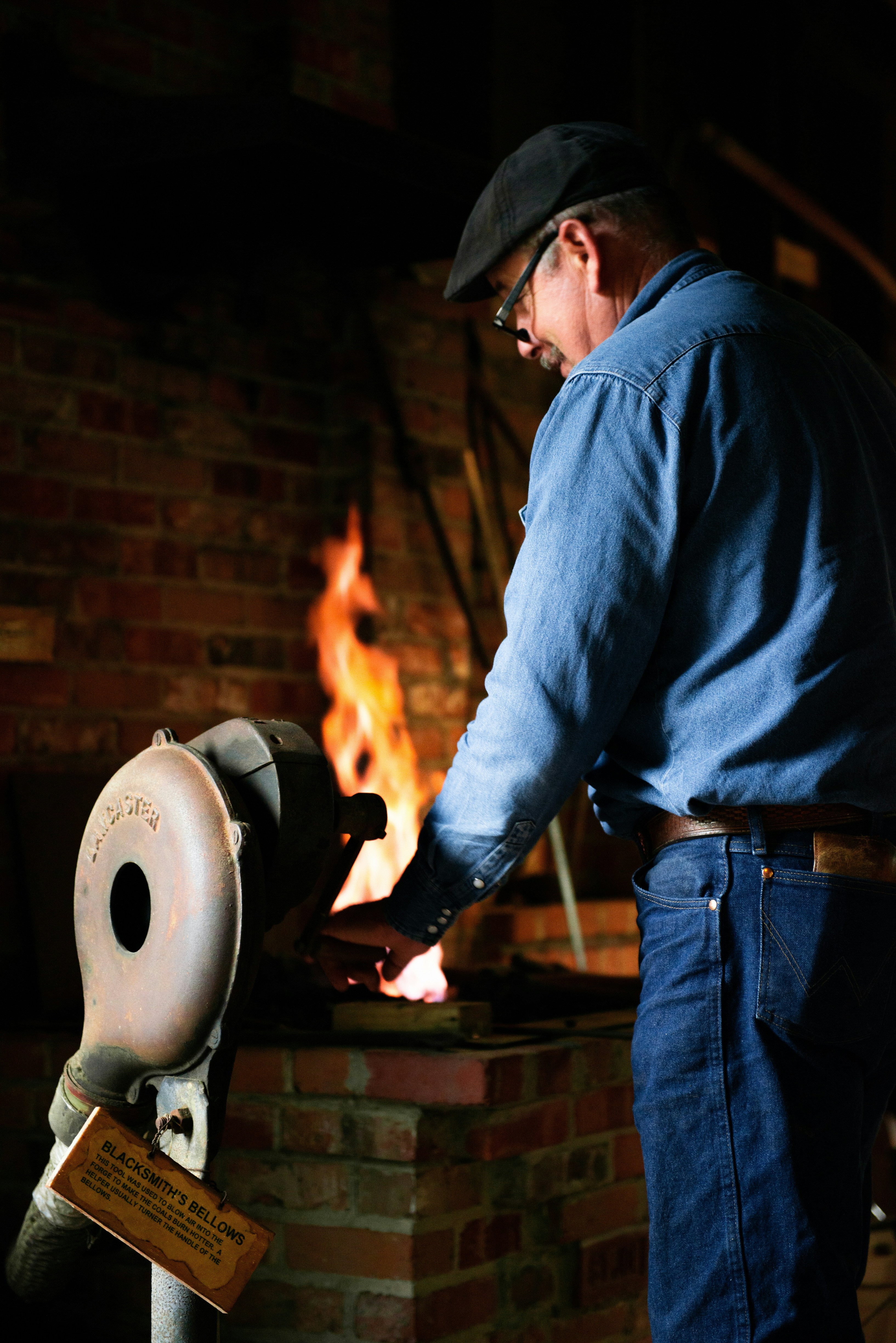 A volunteer demonstrates metal work at the Katy Annual Folk Life Festival.