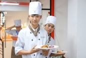 Students attentively learning plating techniques during an advanced cooking class.