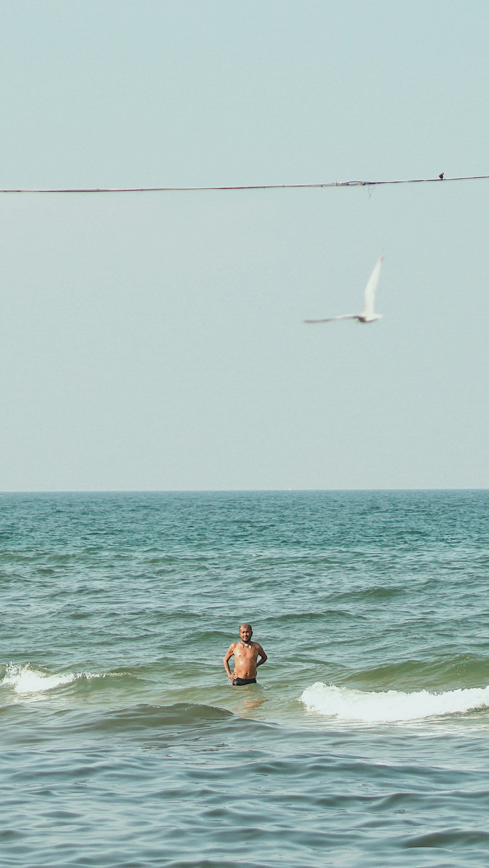 person taking bath on sea