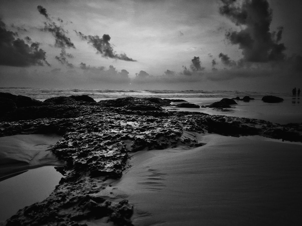 grayscale photography of stones and sand