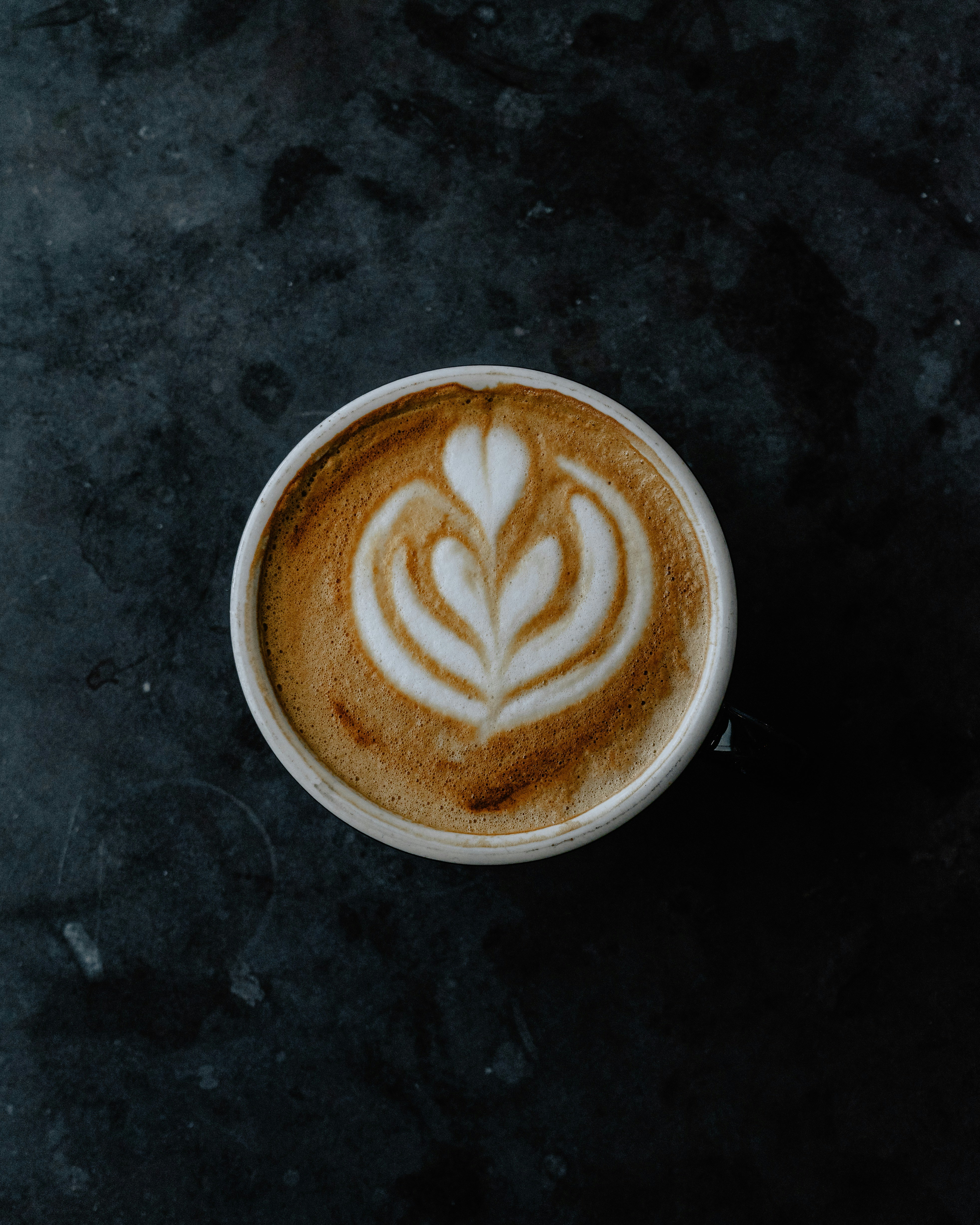 white cup on black surface