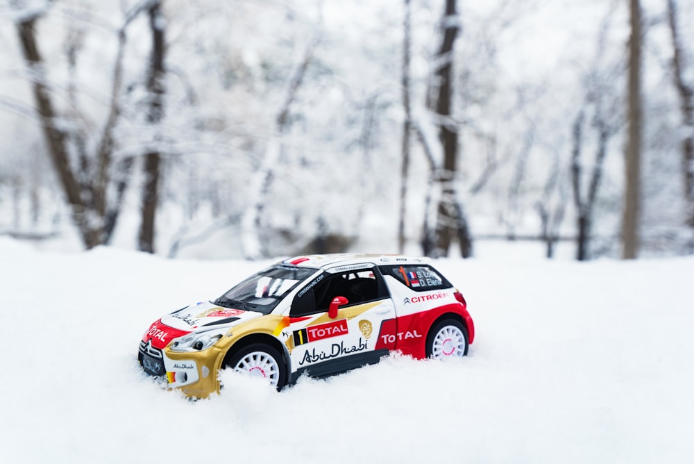 white and red car toy on snow