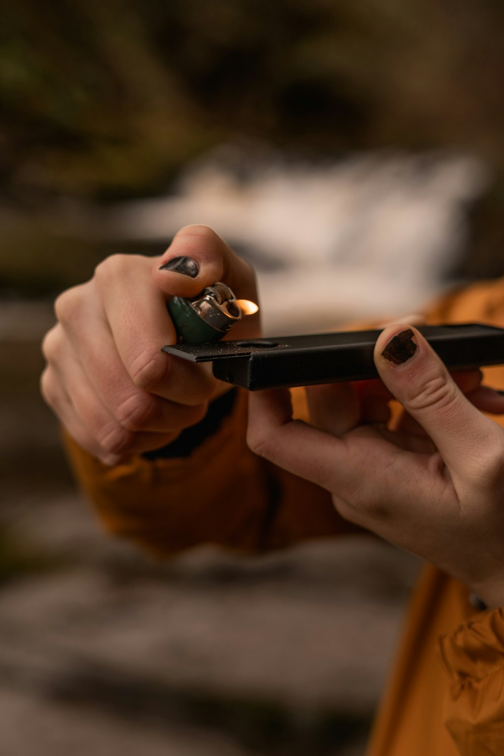 person holding jacket and lighter