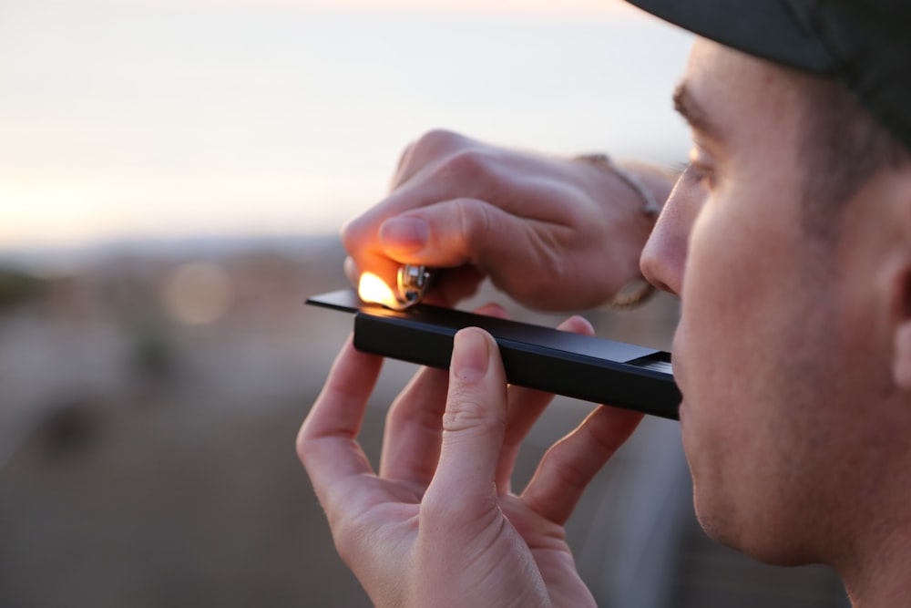 man doing smoke during daytime