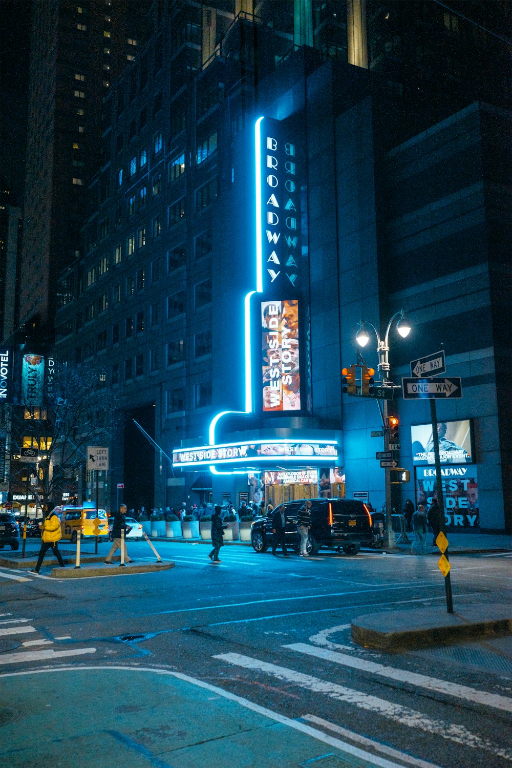 black SUV high-rise buildings during night time