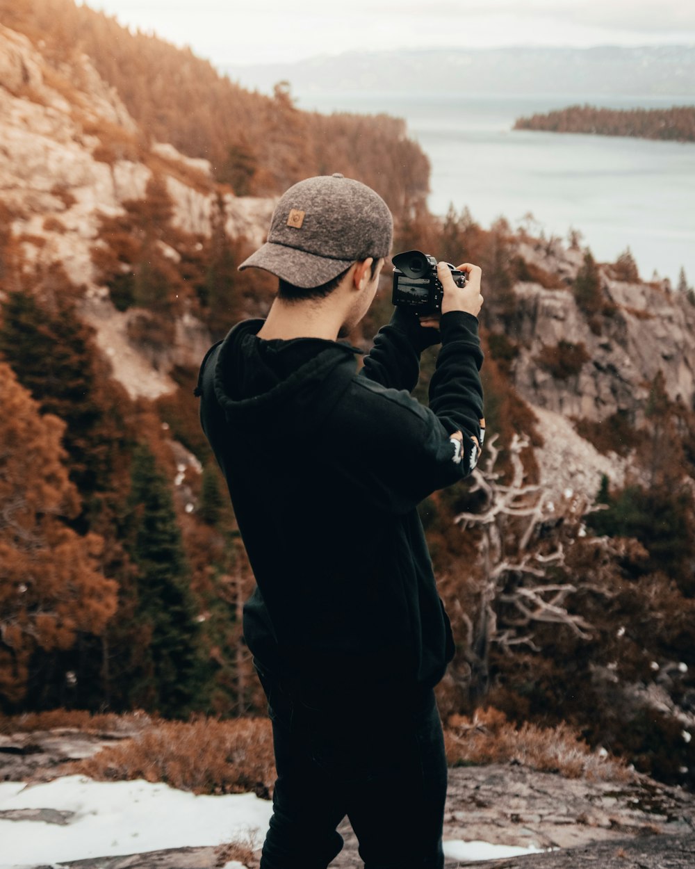 man taking photo in mountain during daytime