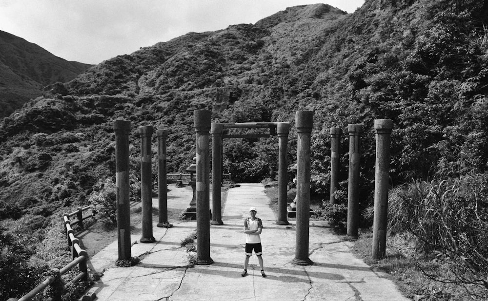 man standing in middle of pillar post