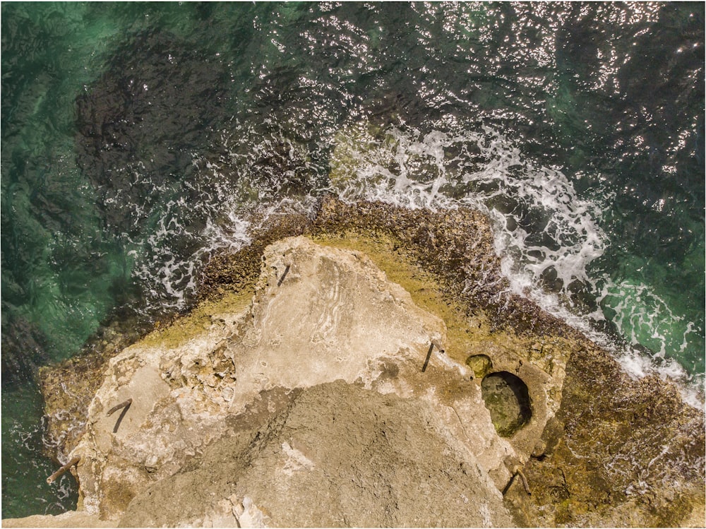 aerial photo of cliff near body of water