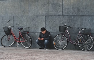 man sitting beside wall