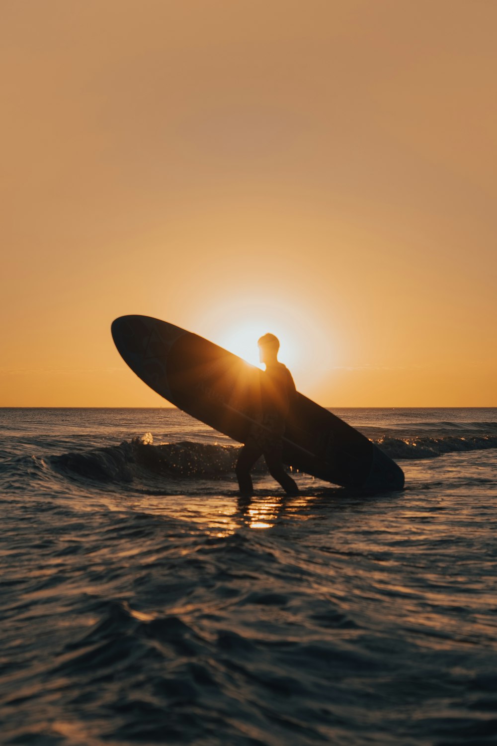 man holding surfboard on the seashore