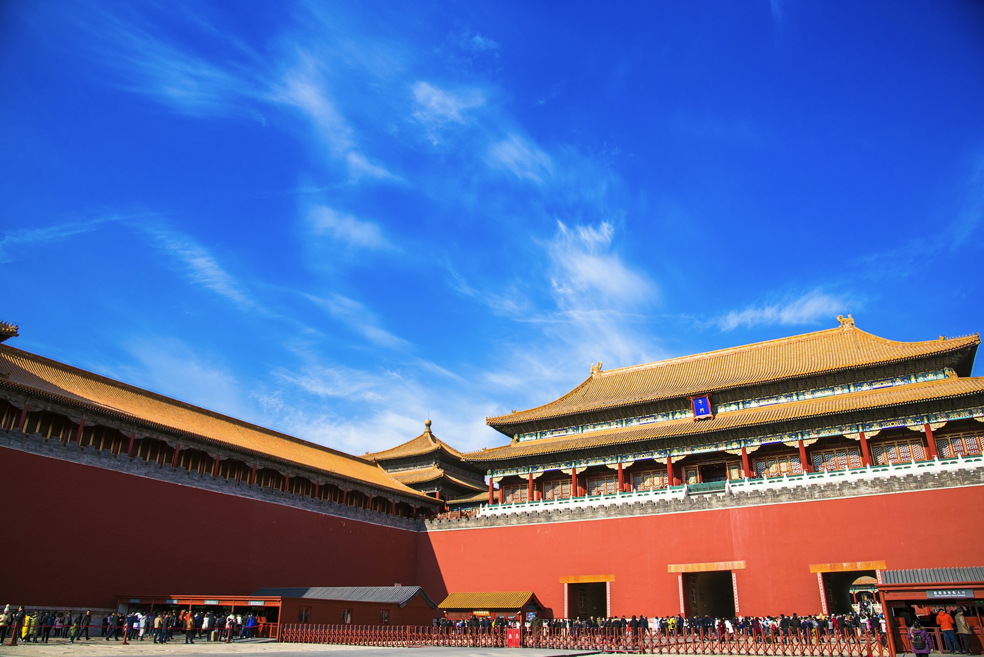 woman wearing yellow long-sleeved dress under white clouds and blue sky during daytime