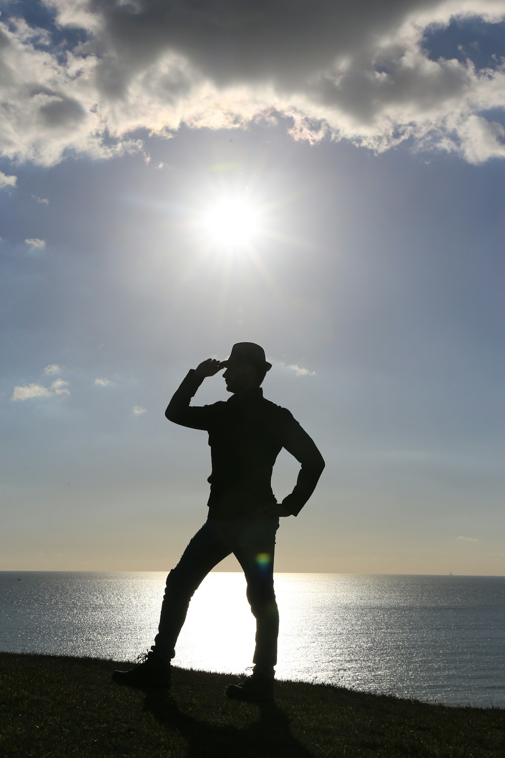 silhouette of man on seashore during daytime