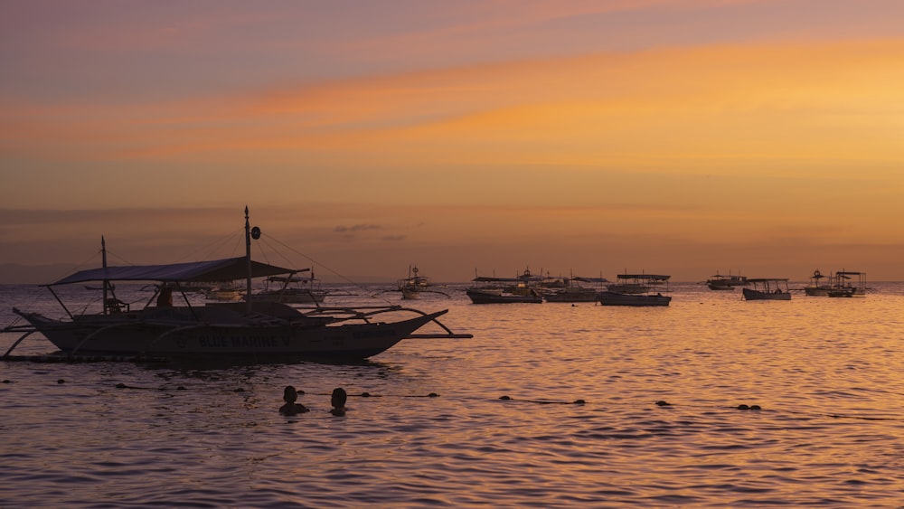 sailboats on body of water during sunset