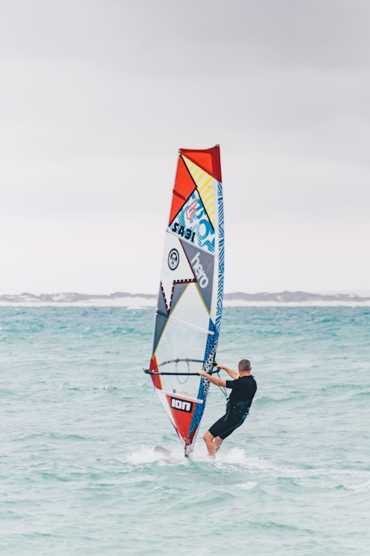 man performs windsurfing in Struisbaai South Africa