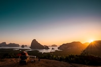 RV trailer on mountain near island during dawn